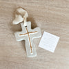 Clay cross gift painted with gray and gold and covered in resin.