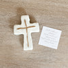 White cross-shaped clay gift .